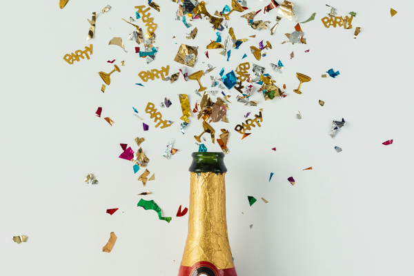 A champaign bottle and confetti