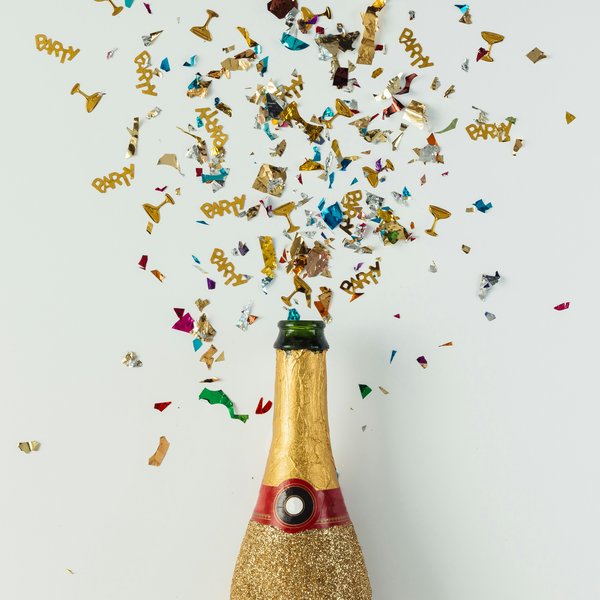 A champaign bottle and confetti