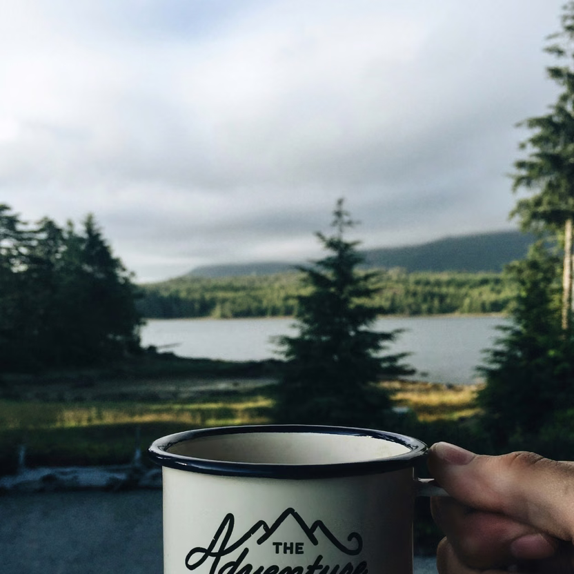 A cup with "adventure begins" written on it
